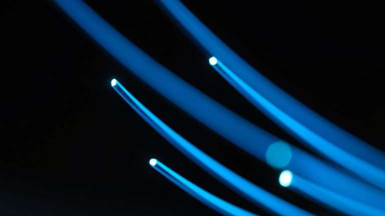 Strands of blue fibre-optic light against black